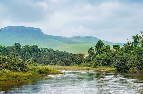 River in the Jungle. Small river in jungle. Under the cloudy sky through hills and mountains the small river proceeds on jungle. Congo. Africa